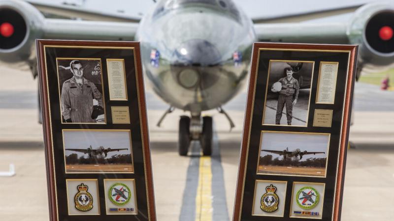 Framed commemorations representing Flying Officer Michael Herbert and Pilot Officer Robert Carver positioned in front of a Canberra Bomber during the 50th anniversary event at RAAF Base Williamtown. Photo: Corporal Brett Sherriff 