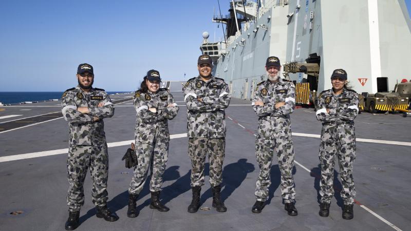 Able Seaman William Nicolaidis, left, Able Seaman Teneille Francis, Able Seaman Hudson Anu, Lieutenant Commander Richard Unwin, and Leading Seaman Kaylin Coleman on the flight deck of HMAS Adelaide during Exercise Sea Wader 2020 off the Queensland coast.