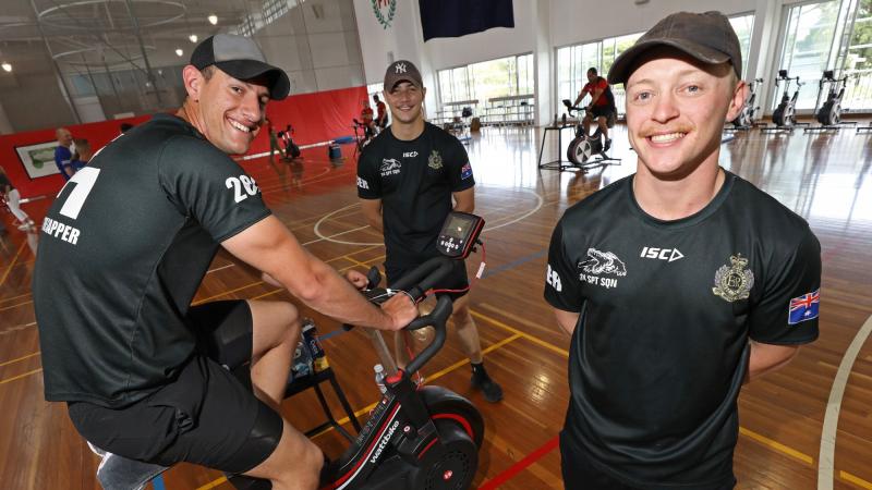Sapper Harrison Chaffey, left, supported by Sappers Braith Wallis and Brandon Subloo during the 42 for 42 endurance fundraising event at Gallipoli Barracks, Enoggera. Photo: Corporal Jesse Kane