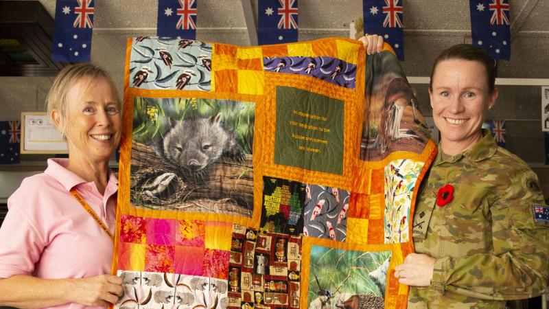 Commander Joint Task Force 633 Major General Susan Coyle presents Aileen Stoddart with an Aussie Hero Quilt at Australia’s main operating base in the Middle East region. Photo: Major Kris Gardiner