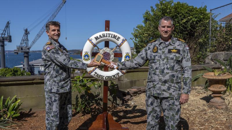 Captain Andrew Quinn, right, hands over 'the weight' to the incoming Commander of the Australian Maritime Task Group, Captain David Tietzel, at Fleet Headquarters in Sydney. Photo: Able Seaman Benjamin Ricketts