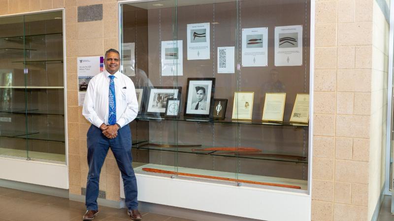 Shane Tongerie in front of the display honouring his grandfather at the RAAF Base Edinburgh airmen's mess . Photo: Leading Aircraftwoman Jacqueline Forrester