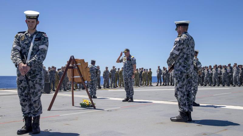 Commanding Officer HMAS Adelaide Captain Jonathon Ley salutes after laying a wreath during the Remembrance Day service held on the ship’s flight deck. Photo: Leading Seaman Nadav Harel