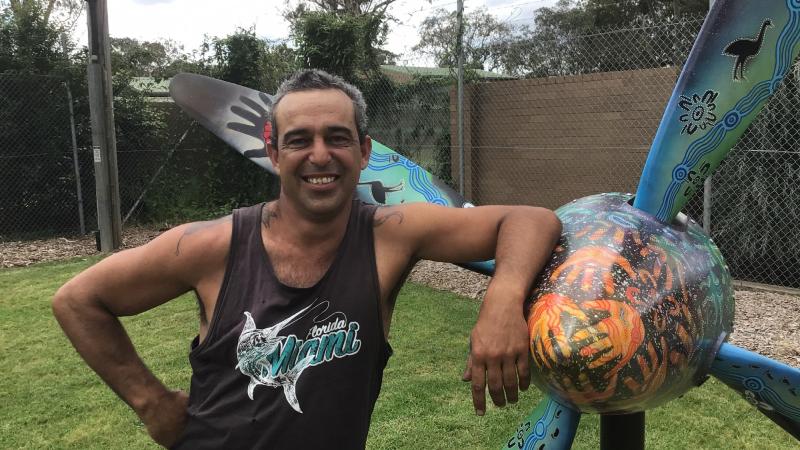 Gunaikurnai artist Alfie Hudson with the PC-9/A propeller he painted, which has been installed at the front gate of RAAF Base East Sale.