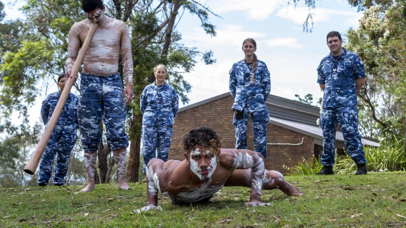 No. 22 Squadron’s Indigenous liaison officer Flight Lieutenant Tjapukai Shaw, front left, and his brother Ngali Shaw perform during NAIDOC Week celebrations at RAAF Base Glenbrook, as base personnel look on. Photo:  Corporal Dan Pinhorn