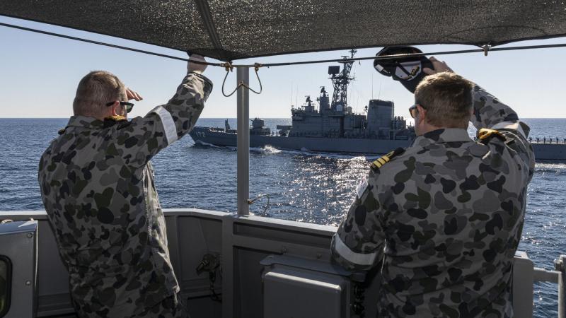 Executive Officer HMAS Arunta Lieutenant Commander David Mason, left, and Commanding Officer Commander Troy Duggan farewell JS Shimakaze at the end of a passage exercise. Photo: Leading Seaman Jarrod Mulvihill
