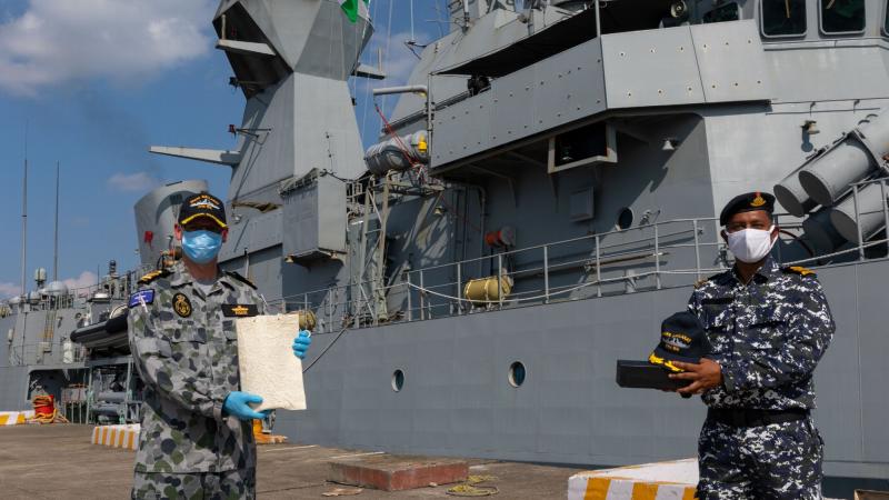 Commander Abhilash Tomy, right, of the Indian Navy training establishment, INS Mandovi, thanks Commanding Officer HMAS Ballarat Commander Antony Pisani for the role the Australian ship played in his rescue in 2018. Photo: Leading Seaman Shane Cameron