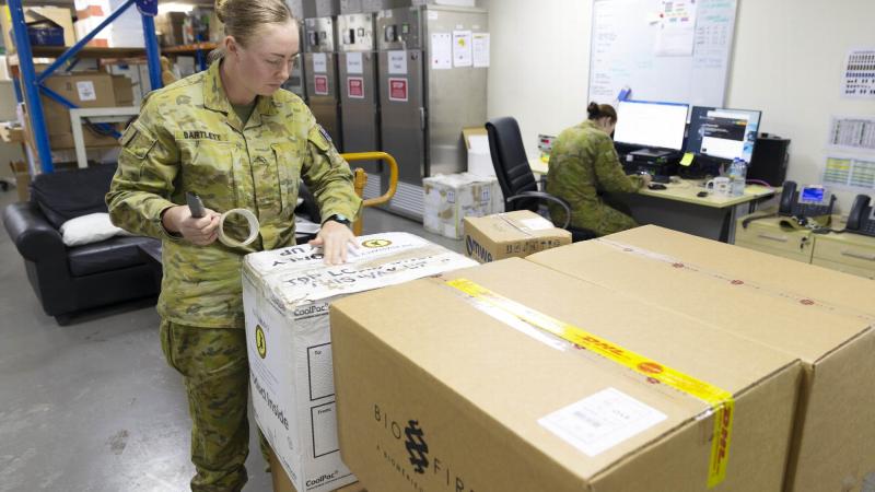 Private Sheridan Bartlett packages COVID-19 testing kits, which were sent from Australia’s main operating base in the Middle East region to the Sinai, Egypt. Photo: Corporal Tristan Kennedy