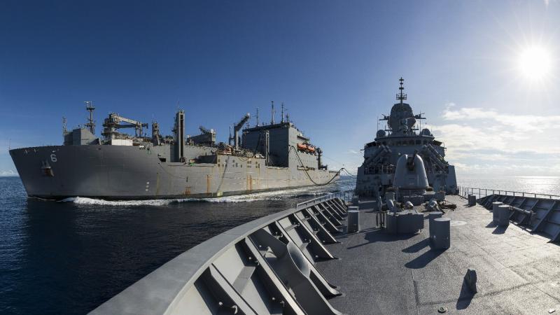 HMAS Arunta, right, conducts a replenishment at sea with United States Naval Ship Amelia Earhart.  Photo: Leading Seaman Jarrod Mulvihill