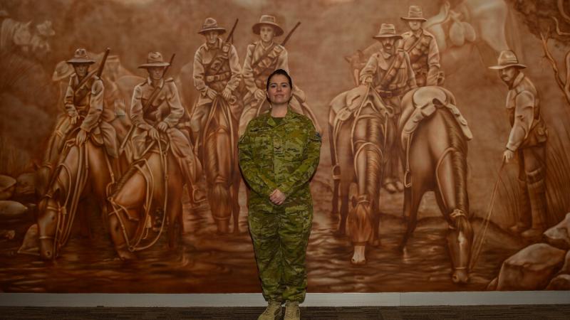 Lance Corporal Jessica Haines-Hann in front of the mural she painted at the Gallipoli Barracks Sergeants' Mess.