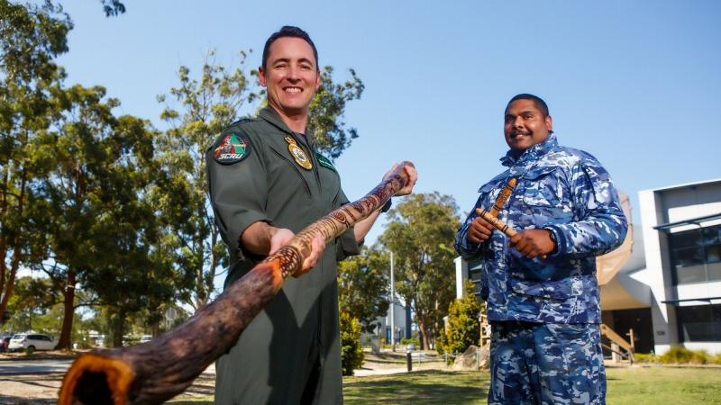 Wing Commander Simon Wildermuth, left, receives a didgeridoo and clapping sticks from the Garby elders of Corindi in Northern NSW, presented by Indigenous Liaison Officer Flight Lieutenant Matthew Roberts. Photo: Corporal Craig Barrett  