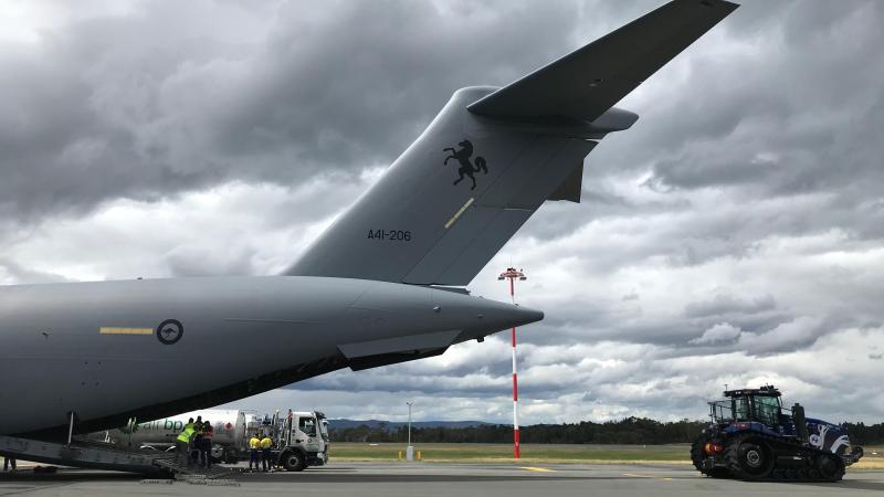 A Caterpillar Challenger traverse tractor is loaded on to a RAAF C-17A Globemaster bound for Antarctica. 