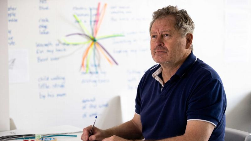 Squadron Leader David Wilkinson in front of his creative writing wall as part of the ARRTS 20.1 program. Photo: Corporal Robert Whitmore