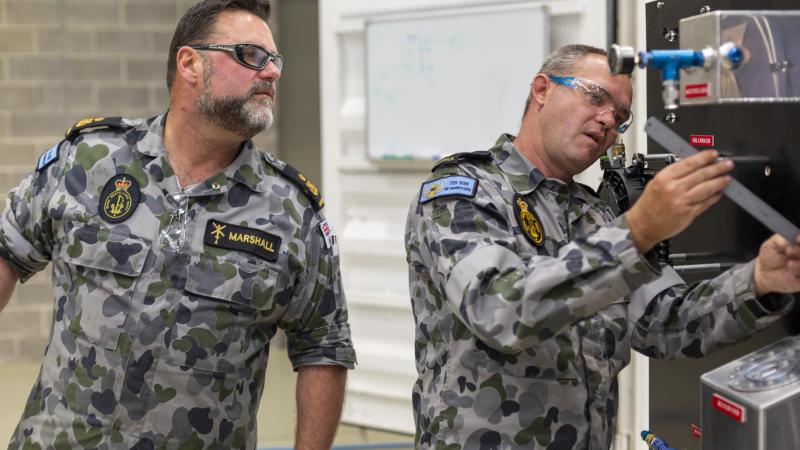Aviation Technicians Aircraft Petty Officer Adam Marshall, left, and Able Seaman Rodney White take measurements during the Navy Engineering Challenge at HMAS Albatross, NSW. Photo: ABIS Benjamin Ricketts