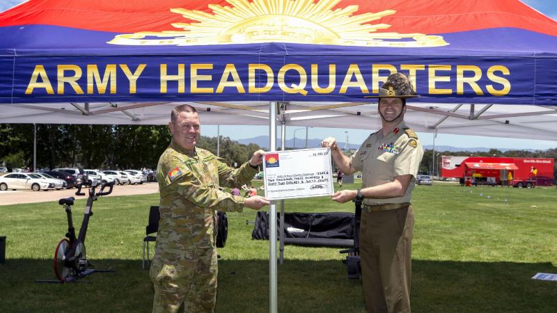 Chief Commissioner Red Shield Defence Services Brett Gallagher, left, accepts a cheque from Deputy Chief of Army Major General Anthony Rawlins at the end of the Army Headquarters' 24-hour Charity Challenge. Photo: Leading Seaman Craig Walton