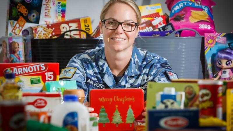 Corporal Jessica Guinan with some of the goods donated by RAAF Base Williamtown personnel to a Salvation Army appeal. Photo: Corporal Craig Barrett