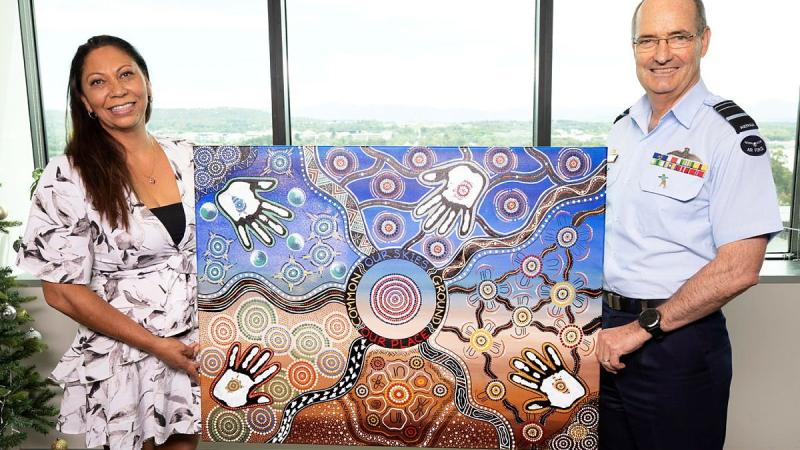 Walbunja artist Katrina Stewart presents her artwork Common Ground to Chief of Air Force Air Marshal Mel Hupfeld at Defence’s Russell offices, Canberra. Photo: Petty Officer Lee-Anne Cooper