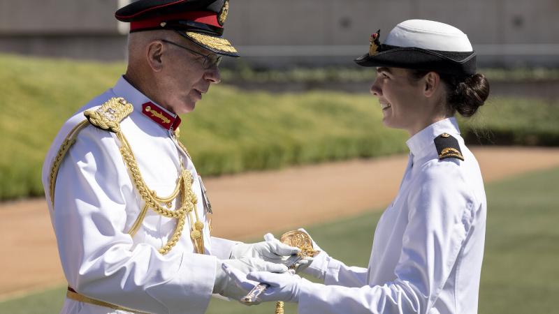 Governor-General General (retd) David Hurley presents the Commander in Chief’s Medal and Sword to now Sub Lieutenant Tiffany McCormack during the 2020 ADFA graduation parade on December 6. Photo: Lauren Larking