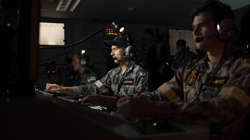 Able Seaman Combat Systems Operator Damon Jackson with fellow crew members in the operations room during the virtual exercise held in the Anzac-class frigate simulator at HMAS Watson in Sydney. Photo: Leading Seaman Jarrod Mulvihill