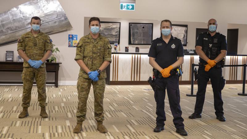 Privates Taylor Cameron, left, and Richard Jonson, of the 6th Battalion, Royal Australian Regiment, on Operation COVID-19 Assist with Queensland Police senior constables Wade Field and David Teunis. Photo: Corporal Nicole Dorrett