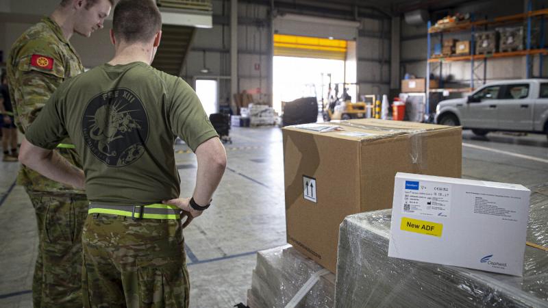 ADF personnel in the Middle East prepare a load of COVID-19 test kits for delivery to Afghanistan. Photo: Sergeant Ben Dempster