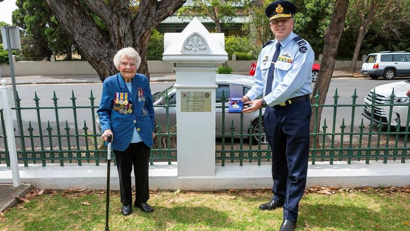 Senior Australian Defence Force Officer - Edinburgh Defence precinct Air Commodore Brendan Rogers presents a US Army Small Ships Section medallion to World War II veteran Thelma Zimmerman. Photo: Leading Aircraftwoman Jacqueline Forrester