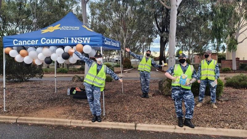 Flying Officers Nancye Prince, left, Rushdi Dai, Curstin Prentice and Jack Walker fundraise for the Cancer Council at the front gate of RAAF Base Wagga.