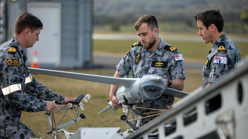 Members of the first Remote Pilot Warfare Officer course load a ScanEagle unmanned aircraft to the launcher before a flight at Jervis Bay Airfield. Photo: Chief Petty Officer Cameron Martin