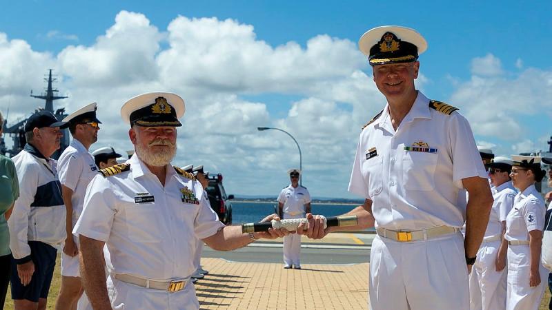 Outgoing Commanding Officer of HMAS Stirling Captain Ainsley Morthorpe, left, hands command to Captain Gary Lawton on the quarterdeck at Fleet Base West, Western Australia. Photo: Leading Seaman Ronnie Baltoft