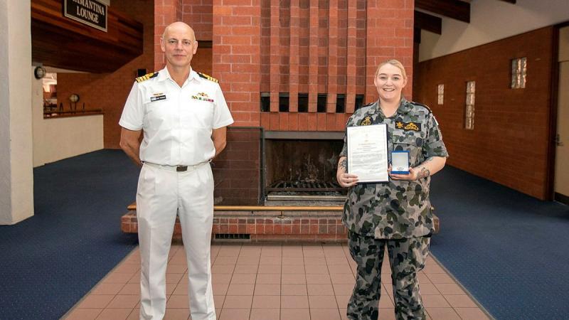 Captain Doug Theobald presents a Fleet Commander silver commendation to Able Seaman Sarah McDonald at an awards ceremony held at HMAS Stirling in Western Australia. Photo: Petty Officer Yuri Ramsey