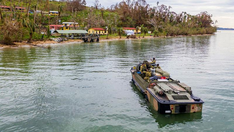 Australian soldiers from the 10th Force Support Battalion drive a Light Amphibious Resupply Cargo 5 onto Galoa.