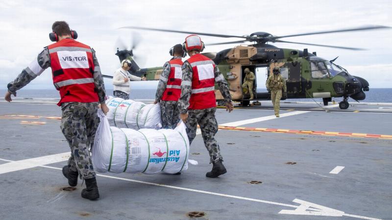 HMAS Adelaide sailors load disaster-relief supplies onto a MRH-90 Taipan bound for Nabouwalu on the island of Vanua Levu, Fiji, during Operation Fiji Assist 20-21. Photo: Corporal Dustin Anderson