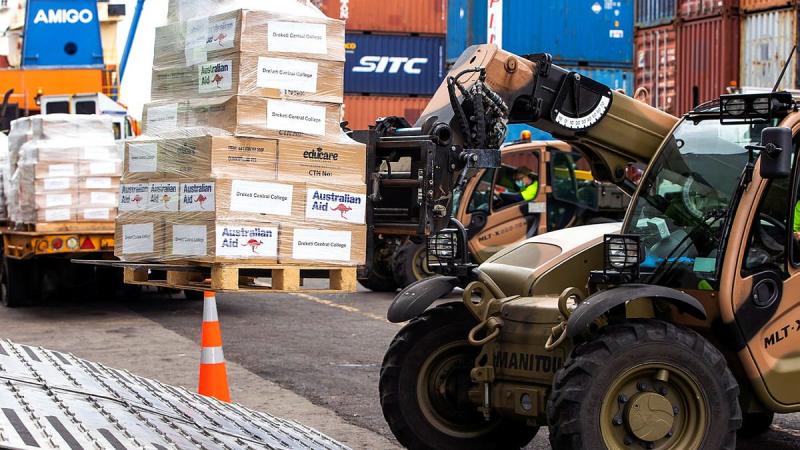 ADF personnel load disaster-relief supplies onto HMAS Adelaide at Kings Wharf in Suva. Photo: Corporal Dustin Anderson
