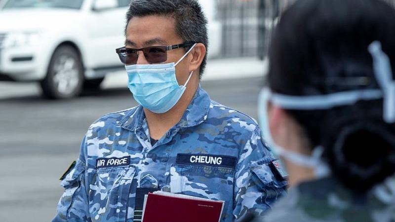 Squadron Leader Harold Cheung briefs Navy personnel at Sydney Airport during Operation COVID-19 Assist. Photo: Leading Seaman Nadav Harel