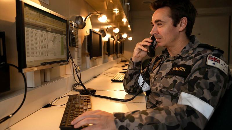 Leading Seaman Christopher Sanders answers a call on board HMAS Adelaide during Operation Fiji Assist. Photo: Corporal Dustin Anderson