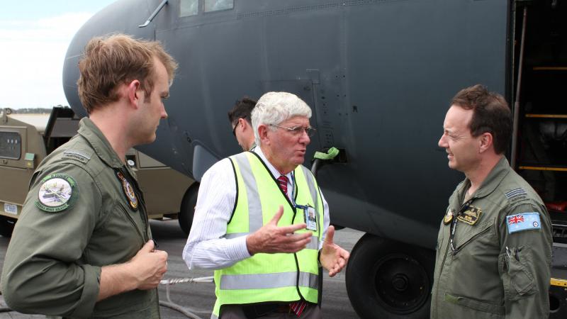 Flying Officer Brett Aaker, left, and Squadron Leader Robert Sokol, right, with Air Force curator David Gardner. 