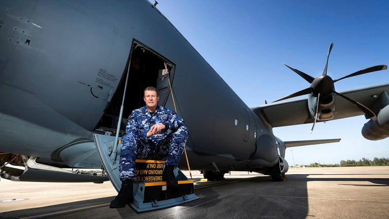 Specialist Reserve Public Affairs Officer Wing Commander Peter Overton on the steps of a No. 37 Squadron C-130J Hercules. Photo: Corporal David Said