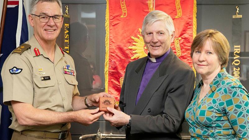  Chief of Army Lieutenant General Rick Burr presents a Federation Star to Bishop Grant Dibden alongside his wife Janet at Russell Offices, Canberra. Photo: Petty Officer Lee-Anne Cooper