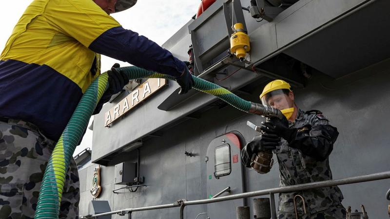 Leading Seaman Jeffrey Drew, left, and Seaman Lachlan Bucknell, prepare to refuel HMAS Ararat at HMAS Coonawarra, Darwin. Photo: Leading Seaman Shane Cameron