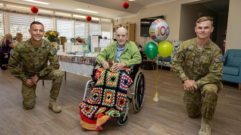 Gunner Matt Freegard, left, and Lance Bombardier Jarrod Colliss, of the 4th Regiment, Royal Australian Artillery with David Shannon on his 100th birthday at Ozcare Townsville. Photo: Corporal Brodie Cross