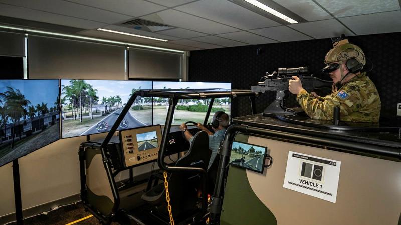 Forces Command Major Andrew Bone and Signaller Jon Taylor, rear, test the new Protected Mobility Tactical Training System at the Battle Simulation Centre, Gallipoli Barracks, Enoggera. Photo: Private Jacob Hilton