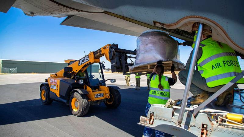 Air Force personnel and Busselton Airport ground crew unload fire retardant from a C-130J Hercules. The retardant will be used by the Department of Fire and Emergency Services Western Australia. Photo: Leading Seaman Richard Cordell