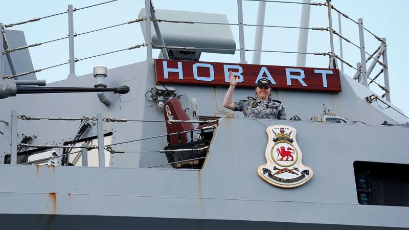 Able Seaman Harriet Shepperd waves from HMAS Hobart while the ship is at anchor on the Derwent River during the Royal Hobart Regatta. Photo: Warrant Officer Class 2 Max Bree