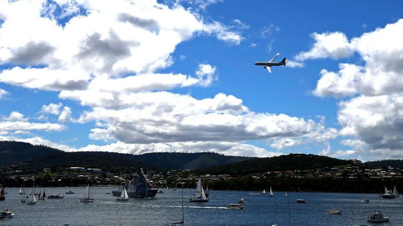 An Air Force P-8A Poseidon aircraft conducts a flypast over HMAS Hobart on the River Derwent during the 2021 Royal Hobart Regatta. Photo: Warrant Officer Class 2 Max Bree