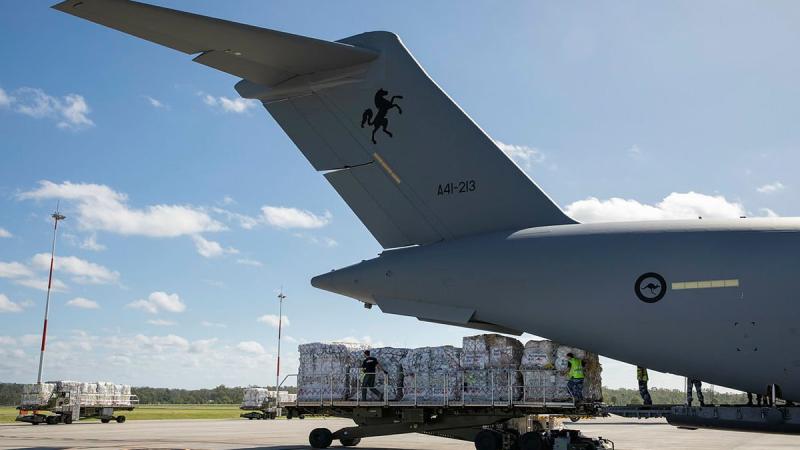 Air Force personnel from No. 23 Squadron load pallets of humanitarian aid bound for Fiji on to a C-17A Globemaster III at RAAF Base Amberley. Photo: Leading Aircraftwoman Emma Schwenke 