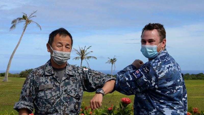 Chaplain Stuart Asquith shares a COVID-safe elbow tap with Warrant Officer Yoshiaki Tanide, of the Japan Air Self-Defense Force at Andersen Air Force Base in Guam. Photo: Technical Sergeant Jerilyn Quintanilla 