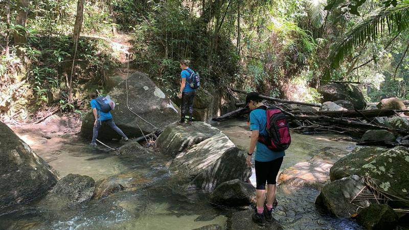 Greer Hawley, Flight Sergeant Sam Williams and Group Captain Gretchen Fryar hike through the hills of Pulau Pinang Malaysia to support the Rose Foundation. 