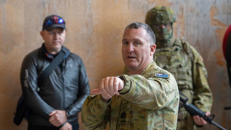Regimental Sergeant Major Warrant Officer Class One Michael Carroll demonstrates urban clearing techniques to medical personnel during a visit to Gallipoli Barracks, Brisbane in 2020. Photo: Trooper Jonathan Goedhart 