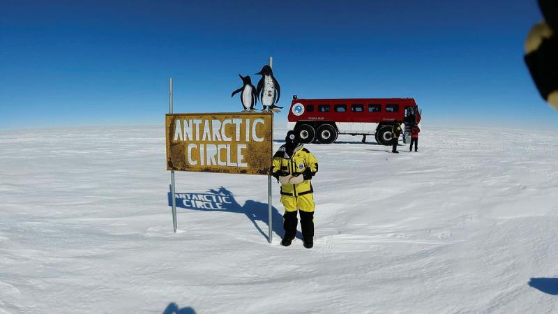 Sergeant Michelle Espley from No. 23 Squadron at the Antarctic Circle sign during Operation Southern Discovery.  
