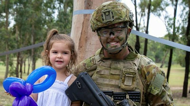 Private Jordan Enright, of the School of Infantry, enjoys the Singleton Military Area family day with his daughter. Photos: Corporal Shane Kelly